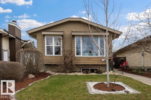 Front exterior featuring tan horizontal siding and shake-style siding accents - 7422 188 Street, Edmonton, AB - Outdoor