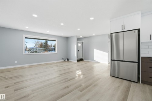 Open concept living space with light wood-style flooring and recessed lighting - 5208 90 Avenue, Edmonton, AB - Indoor