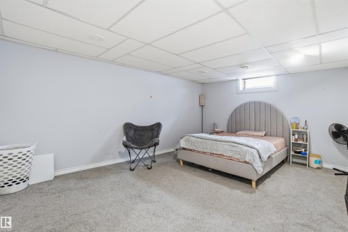 This room features light grey walls, grey carpeting, and a white ceiling with recessed lighting - 5208 90 Avenue, Edmonton, AB - Indoor Photo Showing Bedroom
