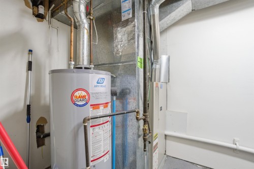 The property includes a water heater and furnace, providing essential utilities - 5208 90 Avenue, Edmonton, AB - Indoor Photo Showing Basement