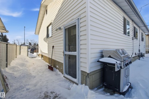 The property features white siding and a screened door - 5208 90 Avenue, Edmonton, AB - Outdoor With Exterior