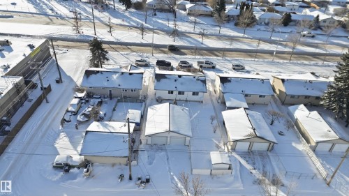 Aerial view of the property and surrounding neighborhood, featuring residential homes with snow-covered roofs and yards - 5208 90 Avenue, Edmonton, AB - Outdoor With View