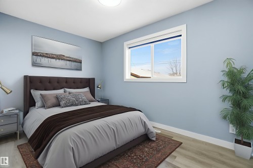 This room features light blue walls, a window with a white frame, and light-colored flooring - 5208 90 Avenue, Edmonton, AB - Indoor Photo Showing Bedroom