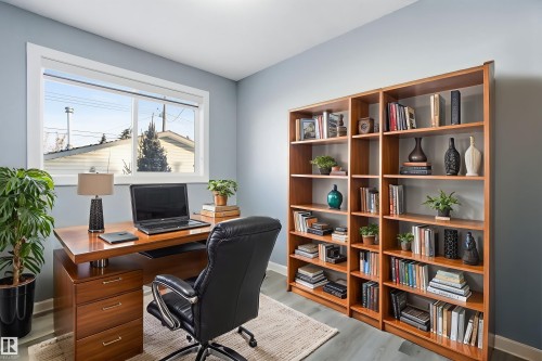 Well-lit room with light blue walls, a window, and wood-style flooring - 5208 90 Avenue, Edmonton, AB - Indoor Photo Showing Office