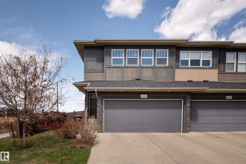 Contemporary multi-story exterior with a two-car garage, stone accents, and varied siding textures - 2704 Koshal Place, Edmonton, AB - Outdoor