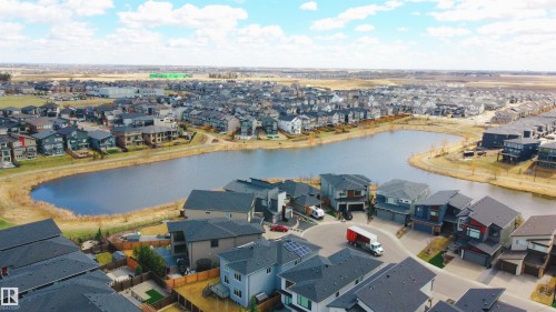 Aerial perspective showcasing a residential community with numerous properties - 2704 Koshal Place, Edmonton, AB - Outdoor With Body Of Water With View