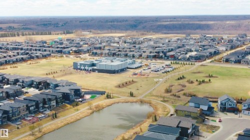 Modern residential development featuring single-family homes and multi-story residences - 2704 Koshal Place, Edmonton, AB - Outdoor With View