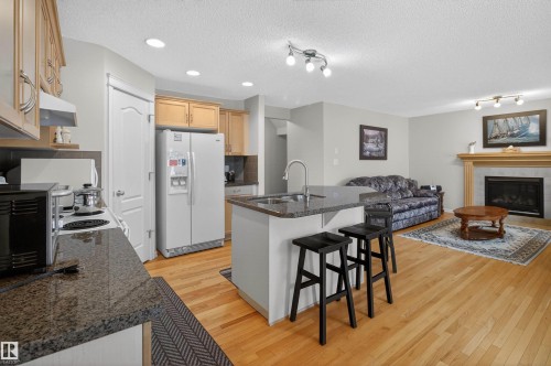 20707 56 Avenue, Edmonton, AB - Indoor Photo Showing Kitchen With Fireplace With Double Sink