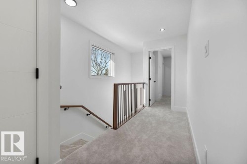 The upper level features carpeted flooring, a window providing natural light, and recessed lighting - 12307 91 St Nw, Edmonton, AB - Indoor Photo Showing Other Room