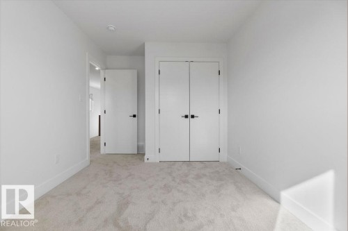 Bright room featuring light grey carpet, white walls, and white trim - 12307 91 St Nw, Edmonton, AB - Indoor Photo Showing Other Room