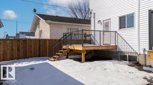 The property features a newly constructed wooden deck with dark railings and steps, providing direct access to the interior - 12307 91 St Nw, Edmonton, AB - Outdoor With Deck Patio Veranda
