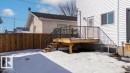 The property features a newly constructed wooden deck with dark railings and steps, providing direct access to the interior - 12307 91 St Nw, Edmonton, AB  - Outdoor With Deck Patio Veranda 
