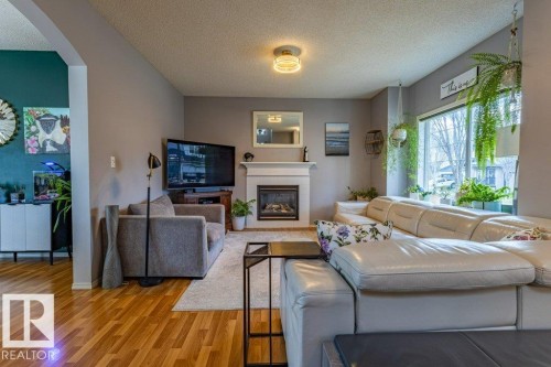 1676 Tomlinson Common, Edmonton, AB - Indoor Photo Showing Living Room With Fireplace