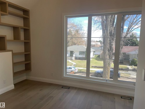 Expansive window offering abundant natural light - 14344 92A Avenue, Edmonton, AB - Indoor Photo Showing Other Room