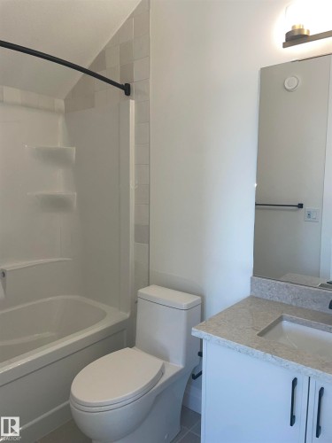 Large picture window with white trim, wood-finish flooring, light-colored walls, and white baseboards - 14344 92A Avenue, Edmonton, AB - Indoor Photo Showing Other Room