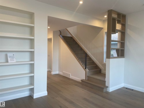 Contemporary staircase featuring blonde wood-finish treads and risers - 14344 92A Avenue, Edmonton, AB - Indoor Photo Showing Other Room