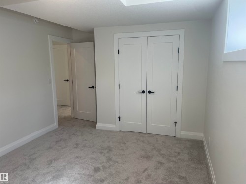 Plush carpeting and crisp white walls define this interior space - 14344 92A Avenue, Edmonton, AB - Indoor Photo Showing Other Room