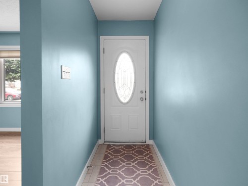 Entryway featuring a white door with an oval decorative glass insert - 8703 73 Street, Edmonton, AB - Indoor Photo Showing Other Room