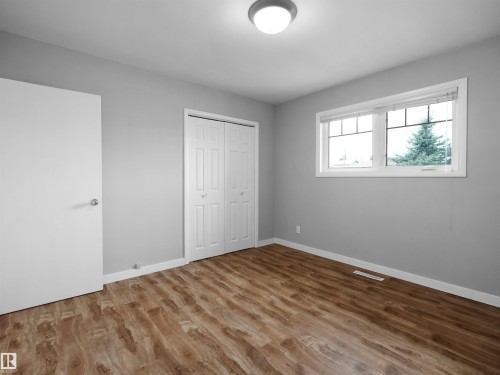 Room with wood-finish flooring, light gray walls, and white trim - 8703 73 Street, Edmonton, AB - Indoor Photo Showing Other Room