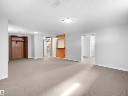 Spacious room featuring neutral carpet flooring, light gray wall finishes, and recessed ceiling lighting - 8703 73 Street, Edmonton, AB - Indoor Photo Showing Other Room