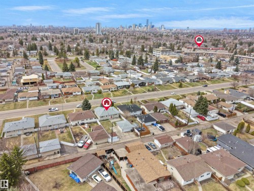 Aerial perspective showcasing a residential neighborhood with a distant cityscape - 8703 73 Street, Edmonton, AB - Outdoor With View