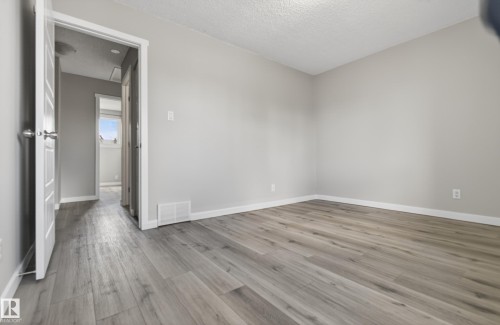 Light gray wood-finish flooring - 18 Lakewood Village, Edmonton, AB - Indoor Photo Showing Other Room