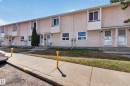 Row of stucco-finished townhomes with individual front entries - 18 Lakewood Village, Edmonton, AB  - Outdoor With Facade 