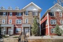 Multi-story townhome featuring varied exterior siding colors, white trim, and dormer windows - 61 2803 James Mowatt Trail, Edmonton, AB  - Outdoor With Facade 