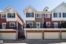 Townhouse exterior featuring a multi-level design with red and tan siding - 61 2803 James Mowatt Trail, Edmonton, AB  - Outdoor With Facade 