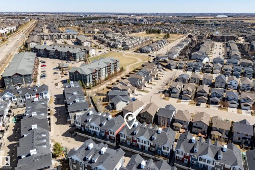 Aerial perspective showcasing a residential development with varied housing styles - 61 2803 James Mowatt Trail, Edmonton, AB - Outdoor With View