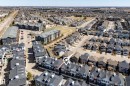 Aerial perspective showcasing a residential development with varied housing styles - 61 2803 James Mowatt Trail, Edmonton, AB  - Outdoor With View 
