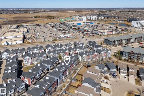 Aerial perspective showcasing a residential development with multiple townhome-style buildings - 61 2803 James Mowatt Trail, Edmonton, AB - Outdoor With View