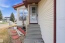 Front entry featuring concrete steps, decorative metal handrail, and a storm door - 1242 Joyce Crescent, Edmonton, AB  - Outdoor 