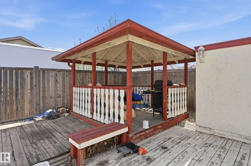 Outdoor gazebo with a red roof, white railings, and a wooden deck - 1242 Joyce Crescent, Edmonton, AB - Outdoor With Exterior