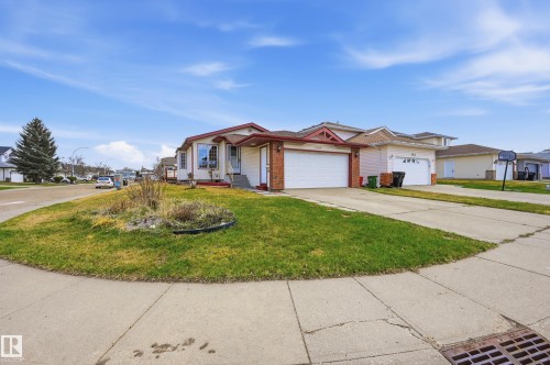Single-story home featuring a white exterior with brick accents and a red-trimmed roof - 1242 Joyce Crescent, Edmonton, AB - Outdoor With Facade