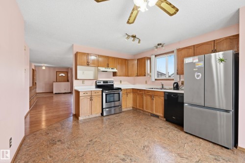 Kitchen featuring wood cabinetry, stainless steel appliances, and a window above the sink - 1242 Joyce Crescent, Edmonton, AB - Indoor Photo Showing Kitchen With Double Sink