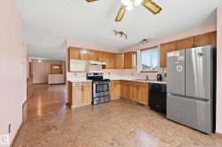 Kitchen featuring wood cabinetry, stainless steel appliances, and a window above the sink - 