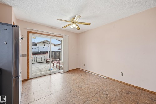 Tiled flooring extending to a sliding glass patio door - 1242 Joyce Crescent, Edmonton, AB - Indoor Photo Showing Other Room