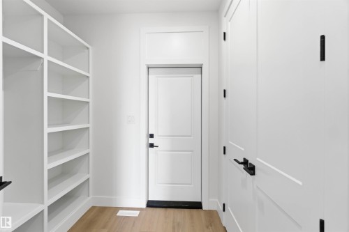 Built-in shelving and cabinetry with matte black hardware - 417 Pine Point(E), Leduc, AB - Indoor
