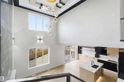 Two-story living area with high ceilings, contemporary chandelier, and light wood-finish flooring - 