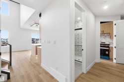 Bright interior showcasing wood-finish flooring throughout - 