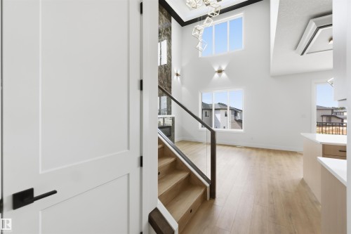 Entryway featuring a white paneled door with matte black hardware - 417 Pine Point(E), Leduc, AB - Indoor Photo Showing Other Room