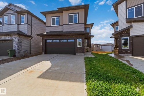 Contemporary two-story exterior featuring a multi-tone facade with stone and horizontal siding - 415 Pine Point(E), Leduc, AB - Outdoor