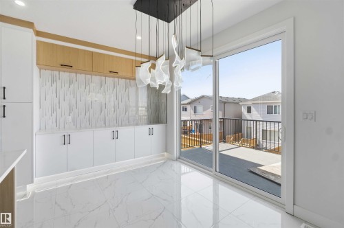 Modern interior space featuring large format marble-look tile flooring - 415 Pine Point(E), Leduc, AB -  With Exterior