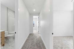 Hallway featuring light gray carpet, recessed lighting, and white walls - 