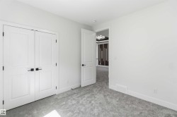 Neutral white walls throughout this space with a plush grey carpet - 