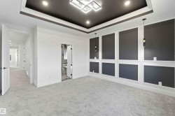 Recessed ceiling with integrated lighting and a central modern chandelier - 