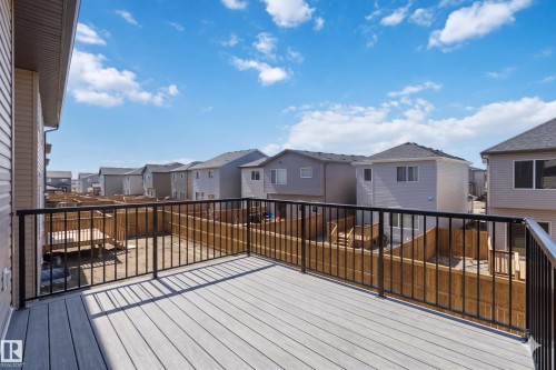 Spacious upper-level deck featuring composite decking and a black metal railing - 415 Pine Point(E), Leduc, AB - Outdoor With Exterior