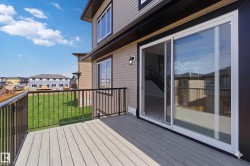 Spacious deck with composite decking and black metal railings - 
