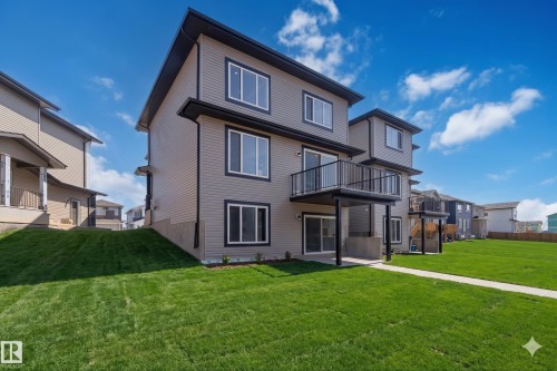 Modern multi-story property featuring a gray siding exterior and black-trimmed windows - 415 Pine Point(E), Leduc, AB - Outdoor With Exterior